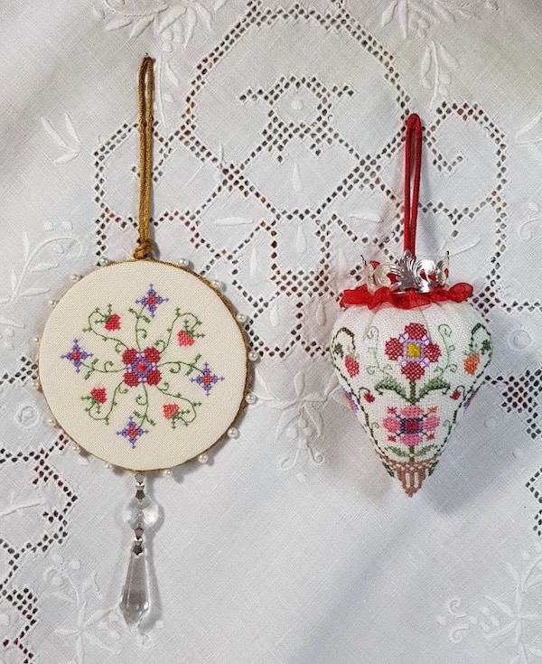 a pinkeep and a strawberry embroidered in colonial williamsburg style
