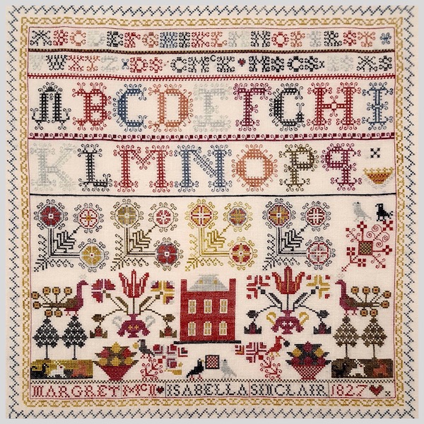 sampler with alphabet and flowers and a house