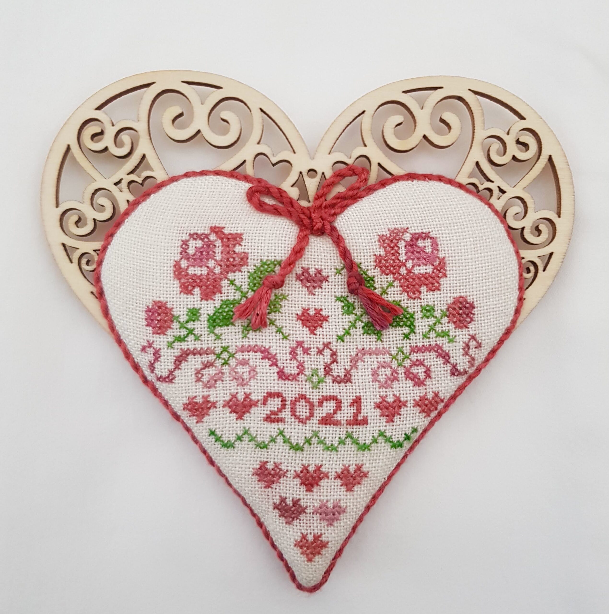 wooden heart with stitched roses one side